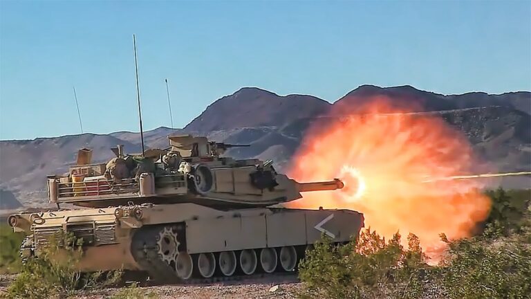 A tank with flames coming out of its main gun.