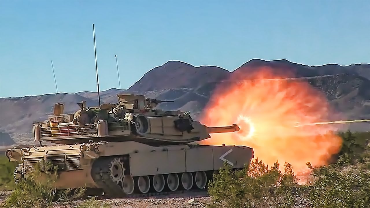 A tank with flames coming out of its main gun.