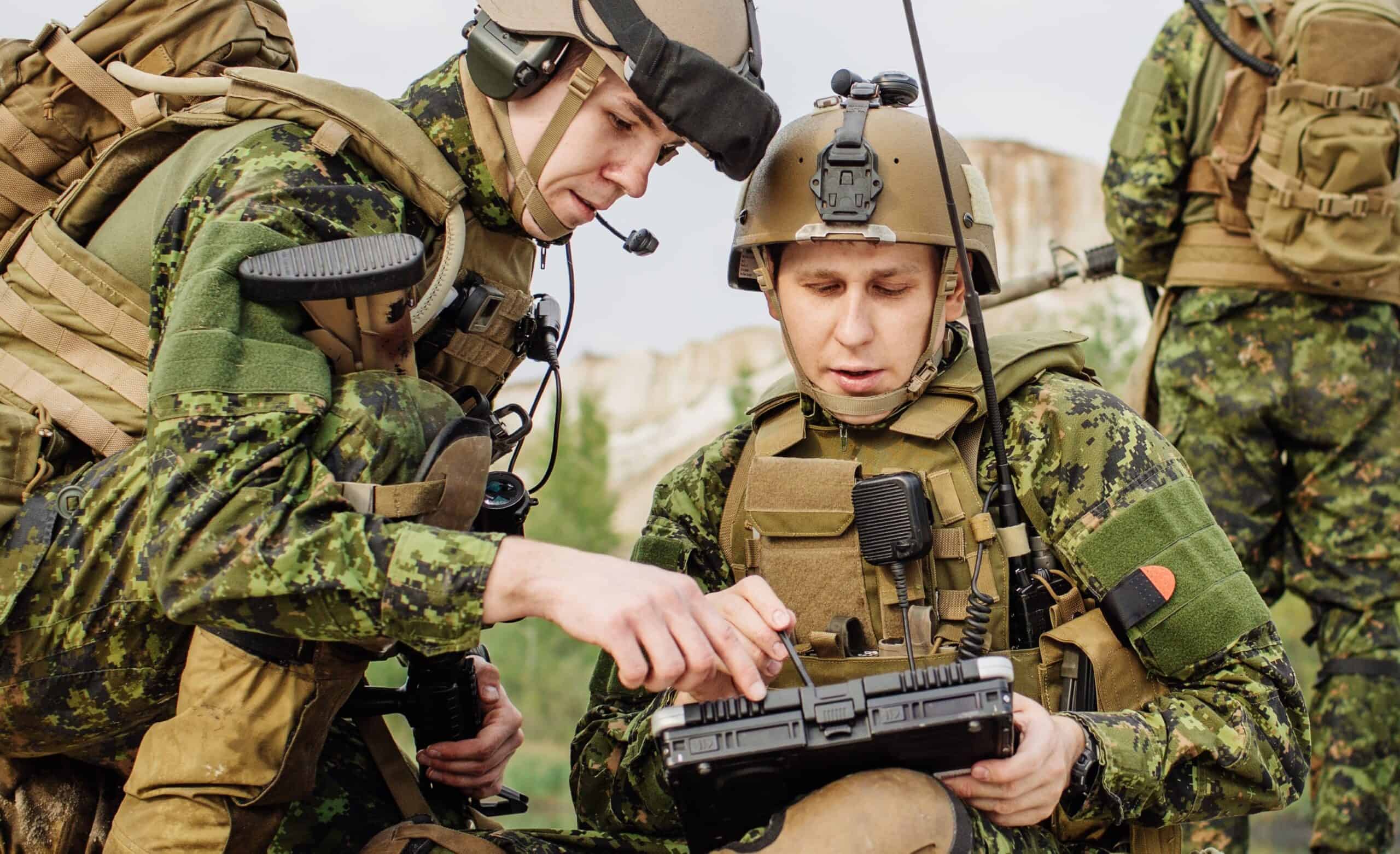 Two soldiers using military communications system.