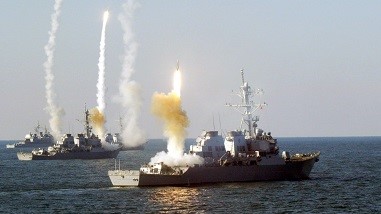A group of ships with missiles in the water.