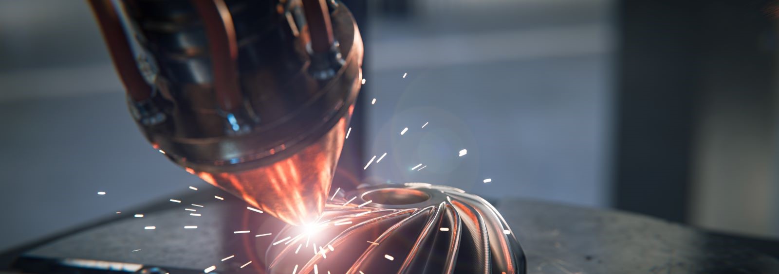 A close-up view of a metal 3D printing process, showing a laser melting and sintering metal powder to create a complex part. Sparking effects are visible at the point of contact.