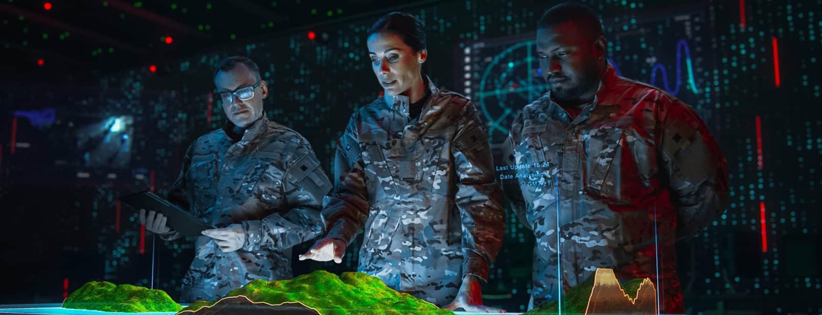 Three soldiers in camouflage uniforms analyze a 3D landscape map in a high-tech room with digital screens displaying data.