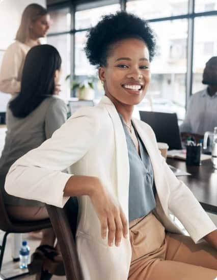 A woman sitting at a desk in a business office.