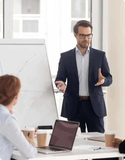 A businessman giving a presentation to a group of people.