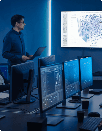 a male standing in front of a monitor with a map on it.