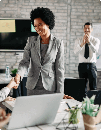 A group of people shaking hands in an office.